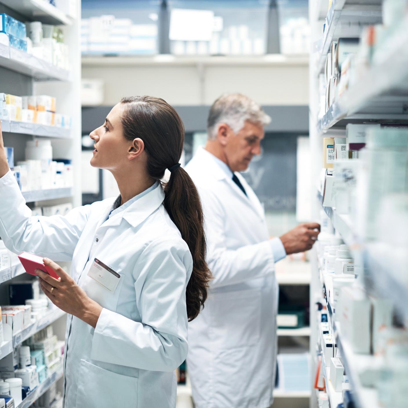 Two pharmacists checking products while working together in a dispensary