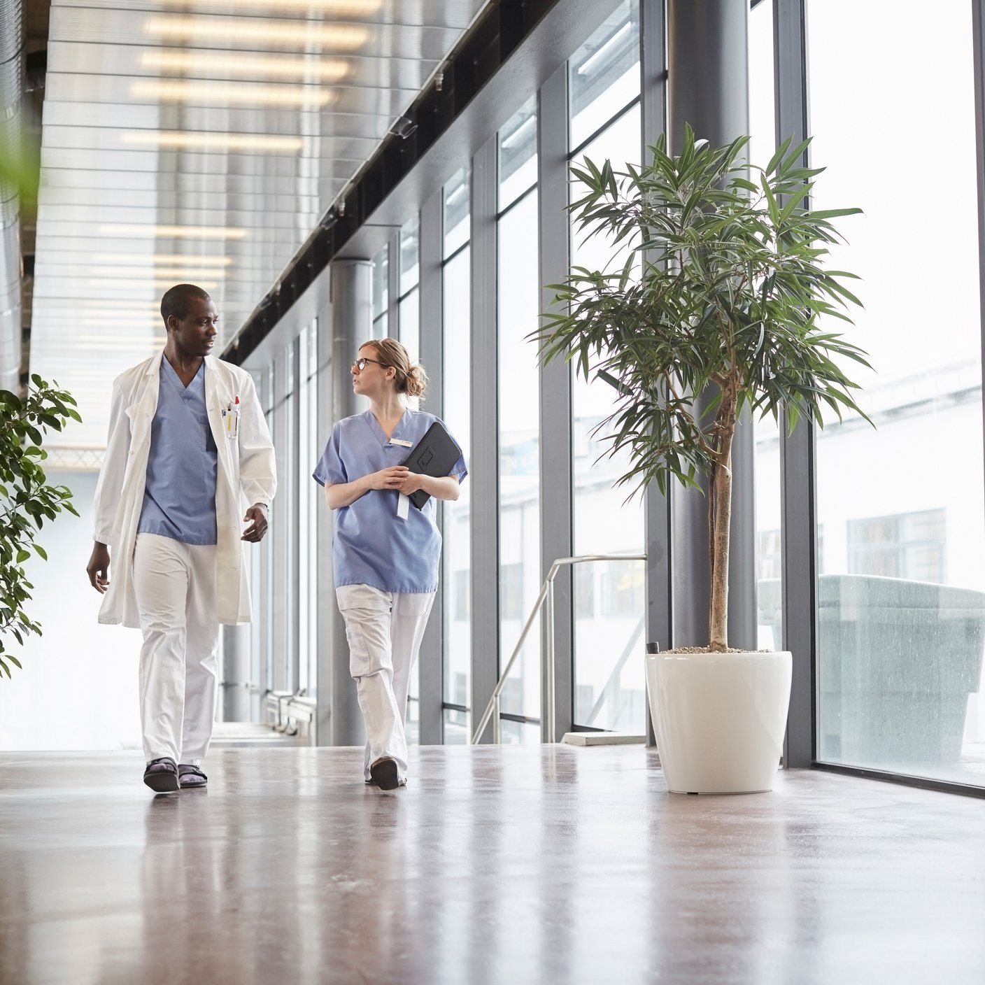 Nurse discussing with doctor while walking in a hospital