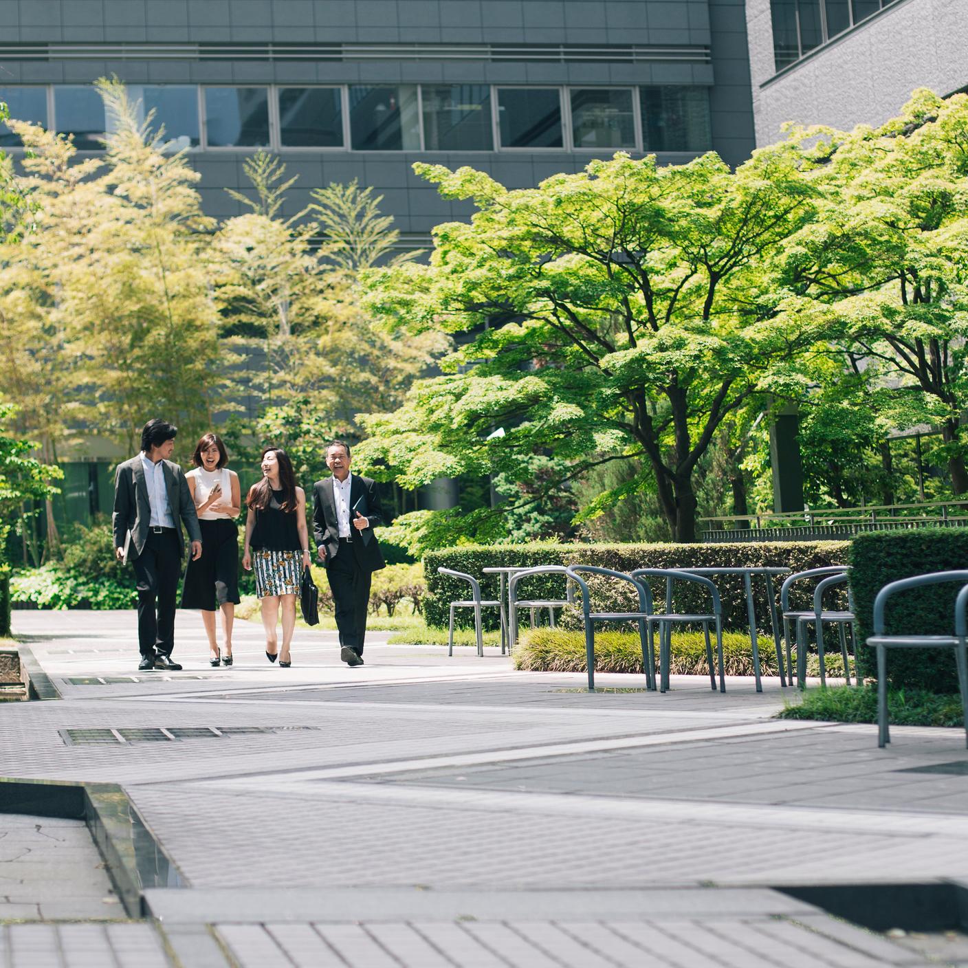 Japanese business people walking through office gardens