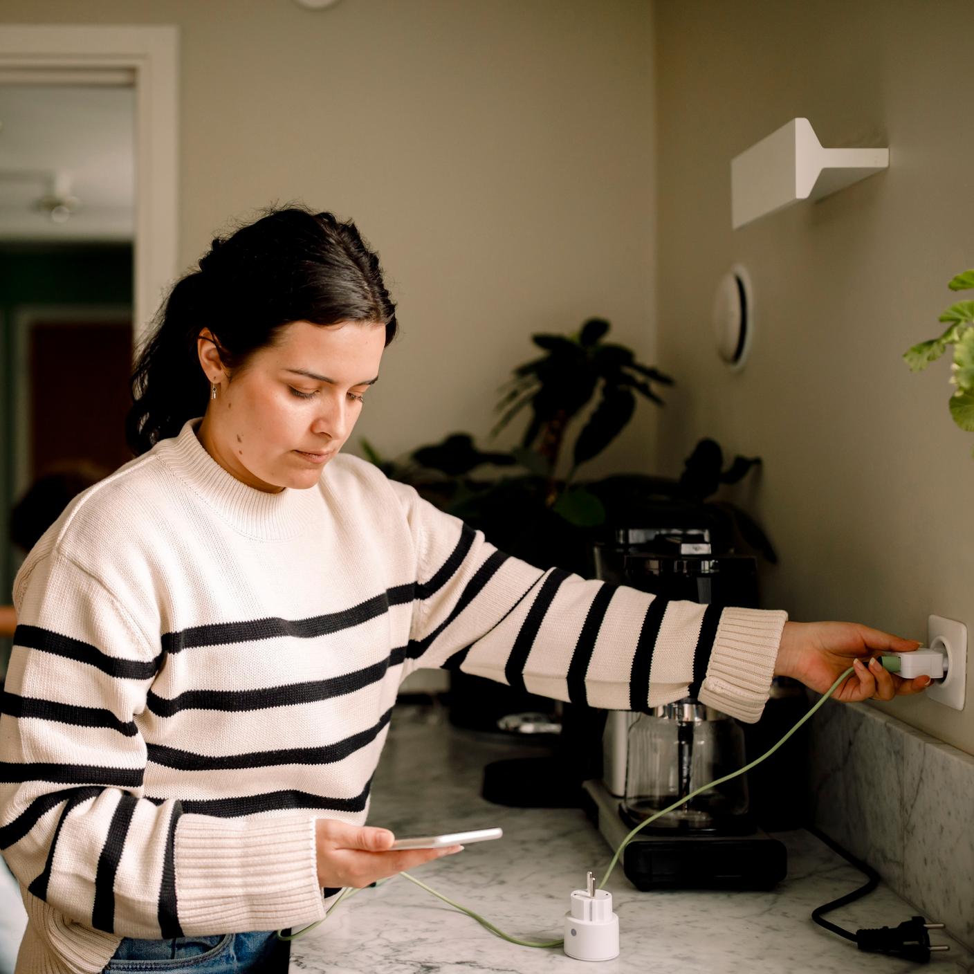 Woman charging smart phone