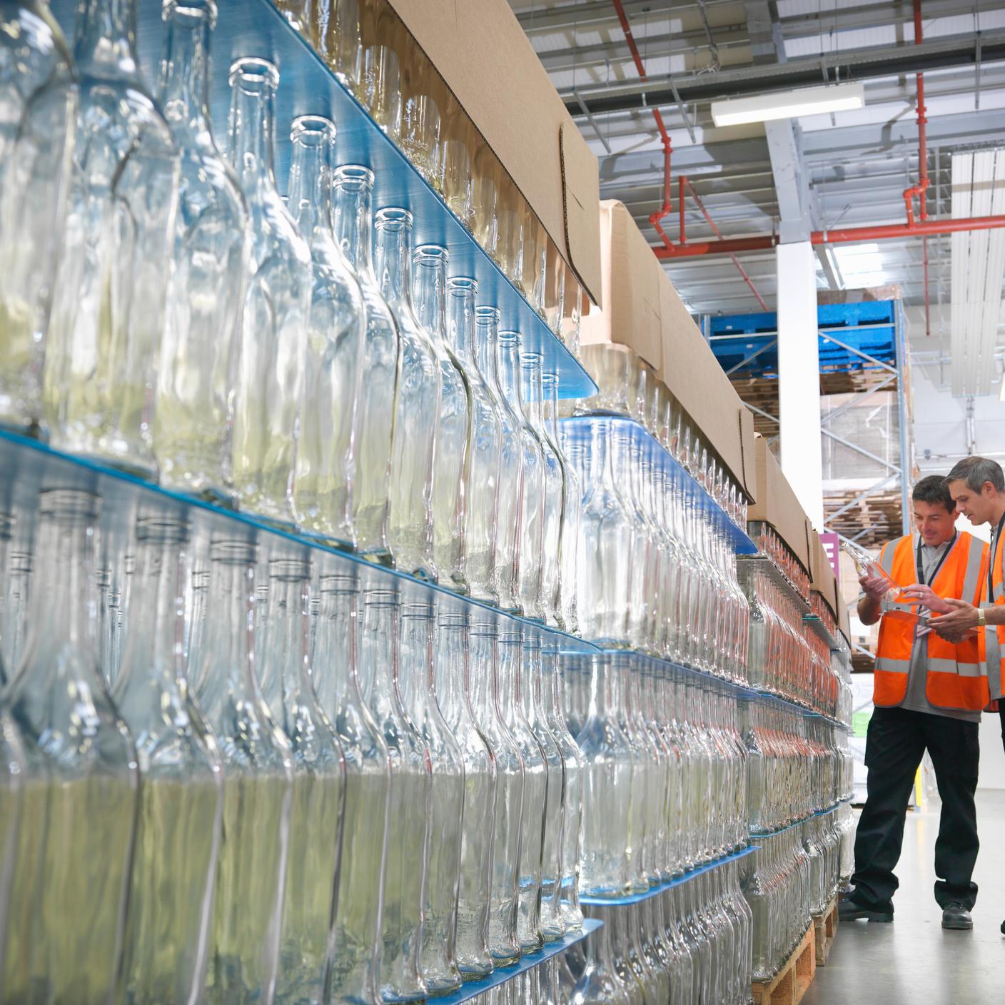 Factory workers examining bottles