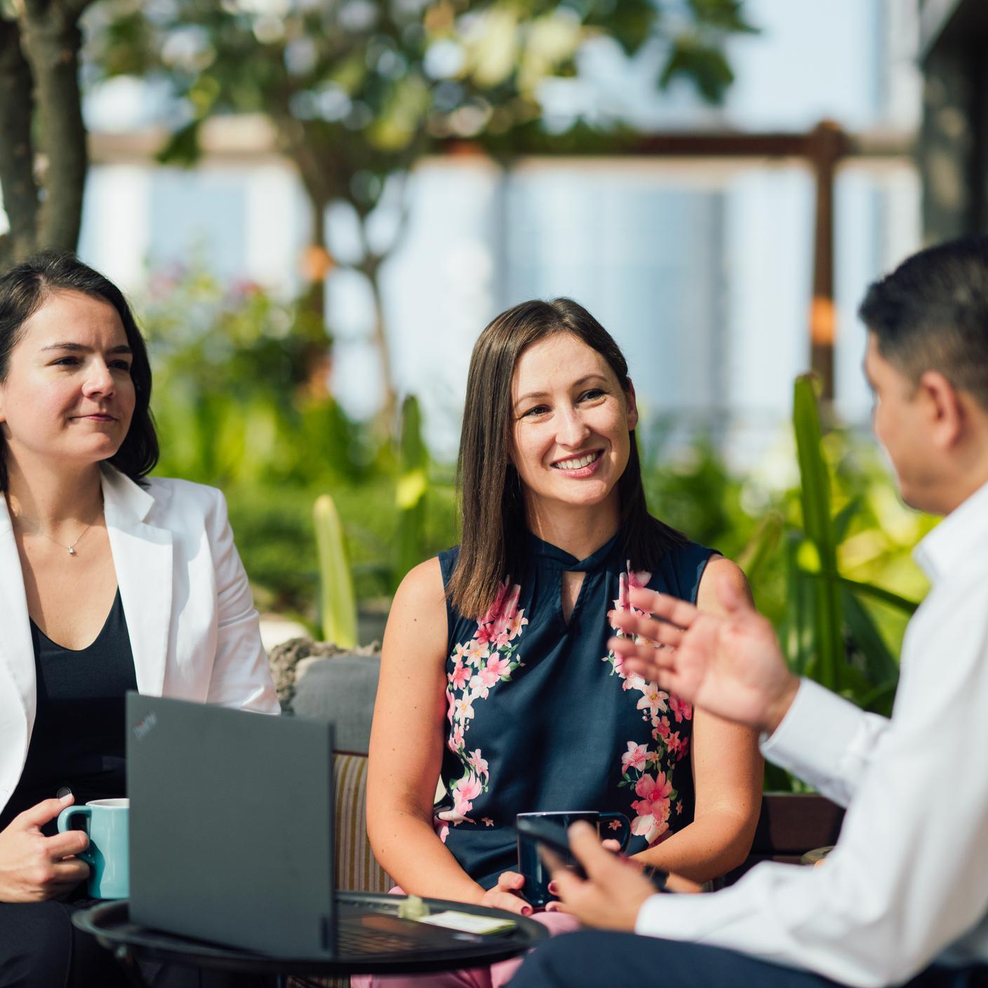 A man and two women discussing