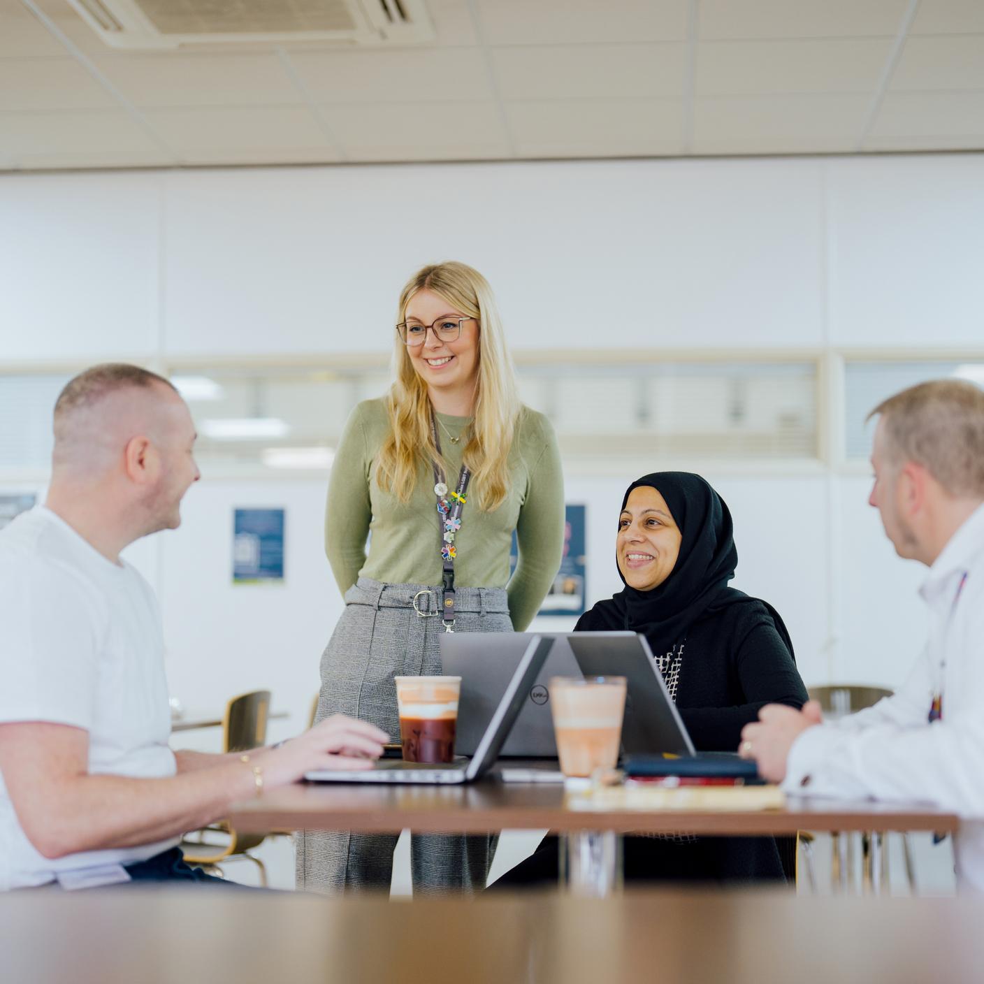 Colleagues working and discussing togheter around a table