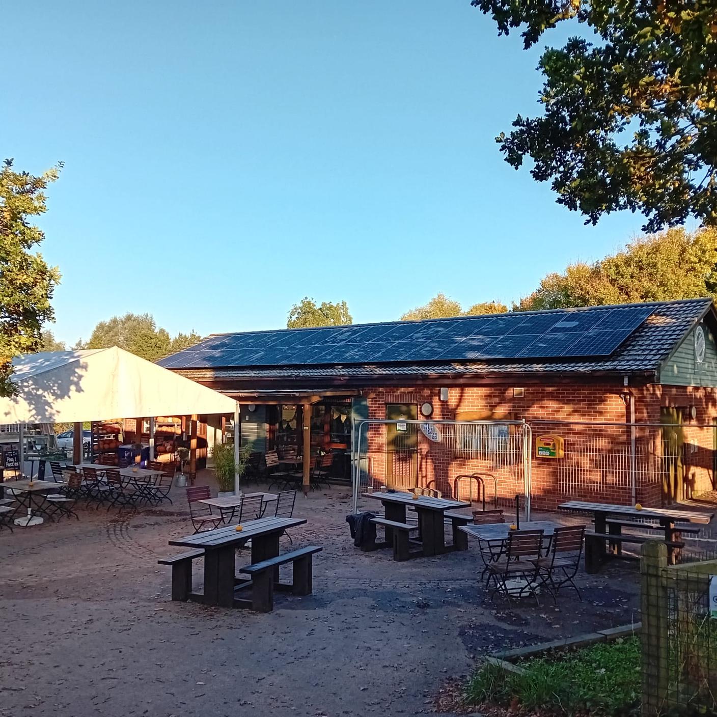 An outdoor building with picnic benches and a marquee in Warwickshire