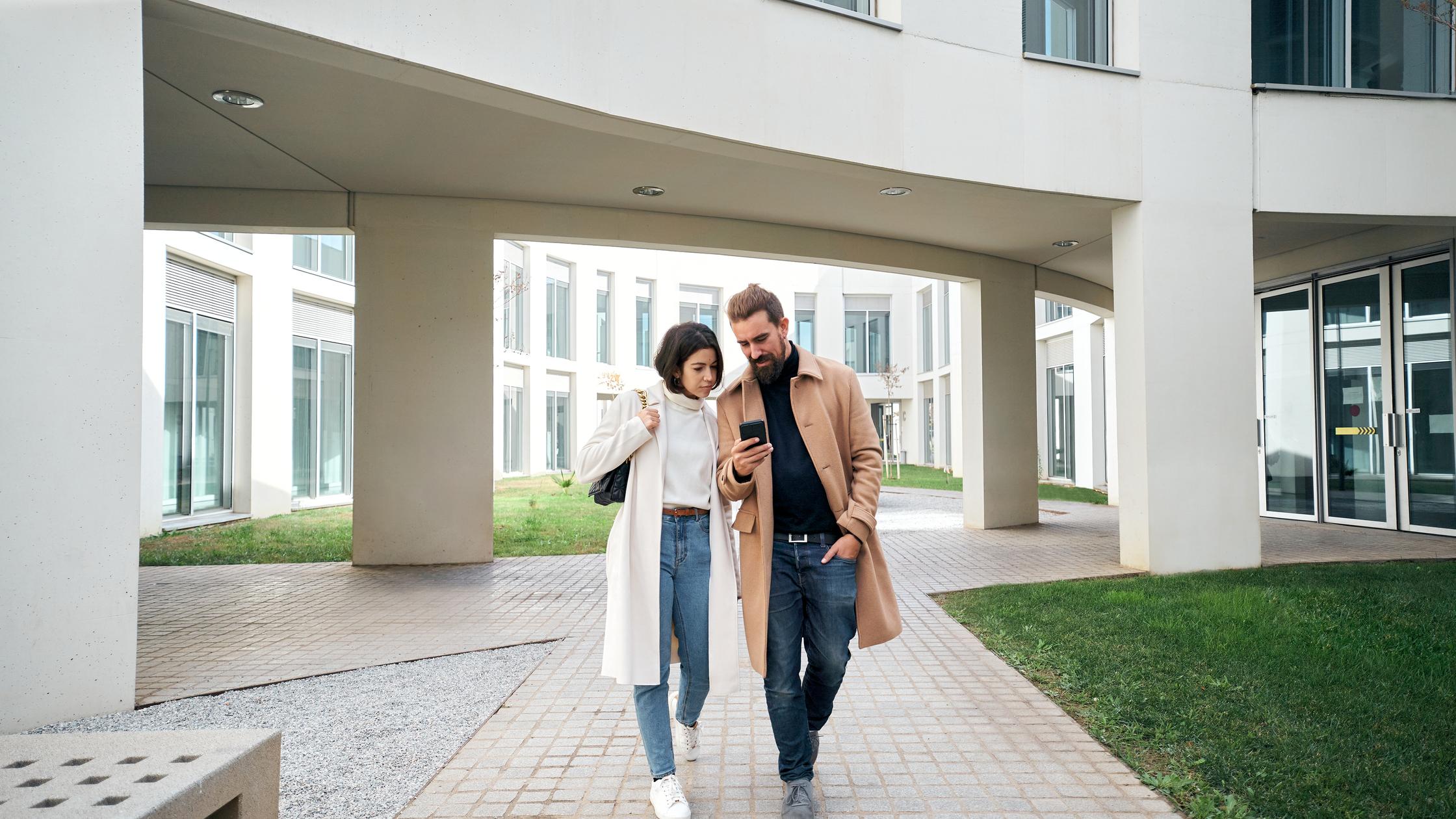 built environment  couple walking by a building area