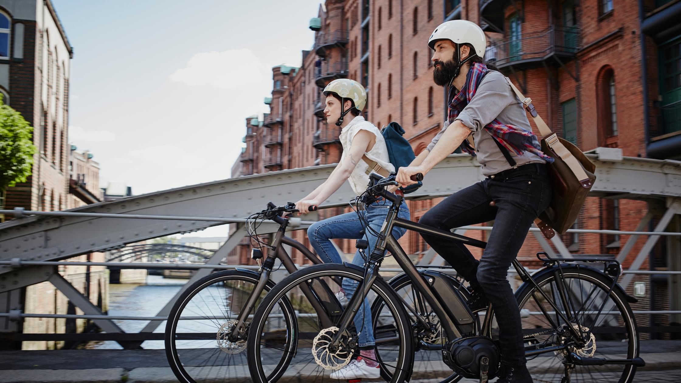 sustainable infrastructure couple riding electric bicycles 