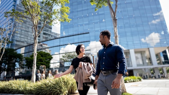 Coworkers talking while walking in the street