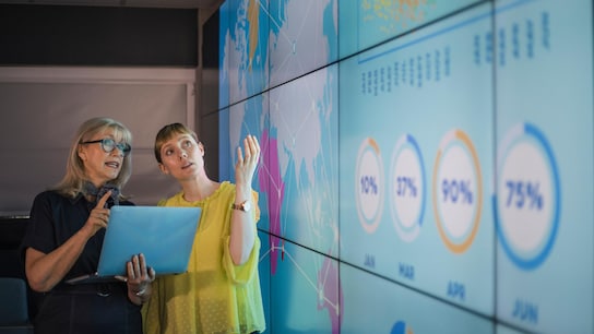 An experienced woman mentors a female colleague